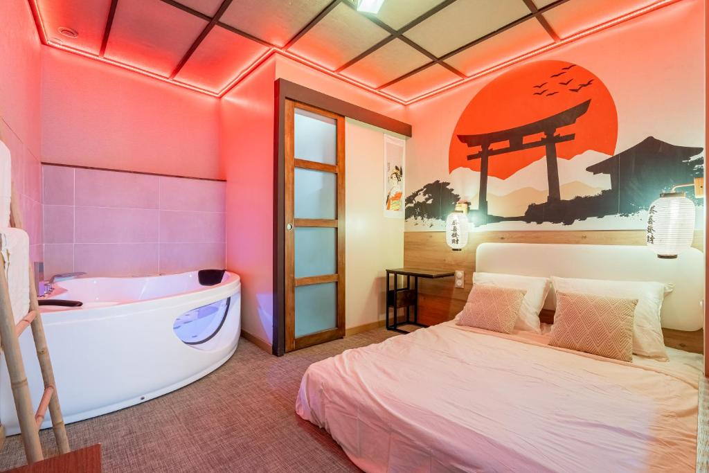 a bedroom with a bed and a bath tub at Le Bain de Sakura - Hypercentre in Marseille