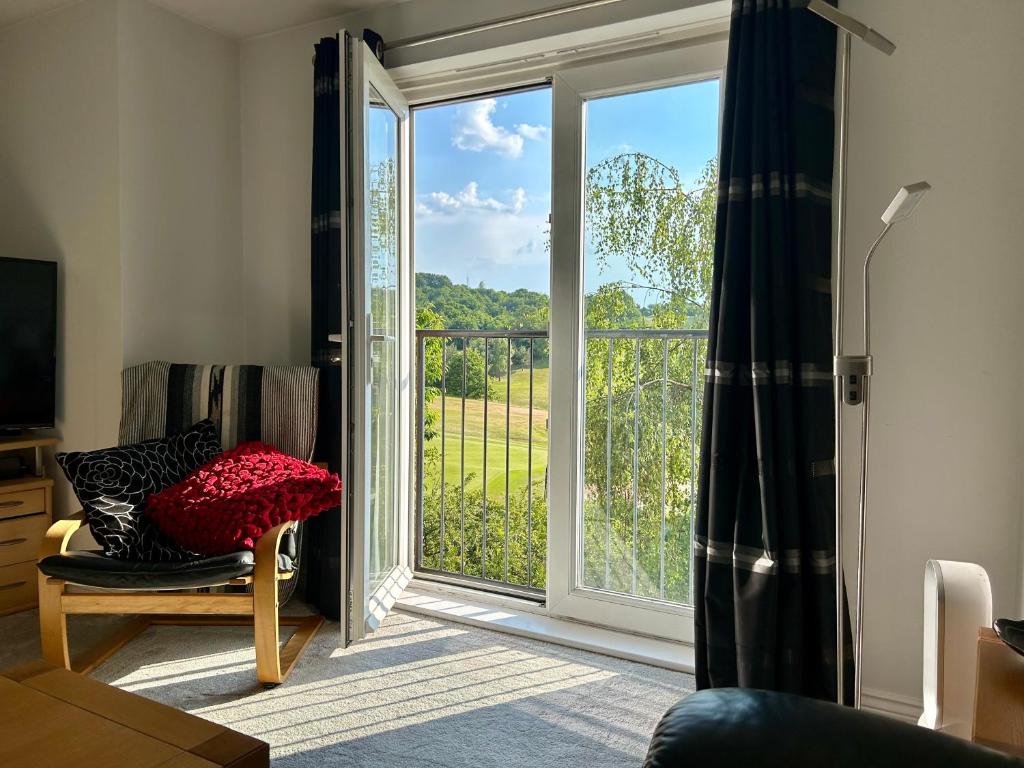 a living room with a sliding glass door with a view at Light & Airy flat, Amazing view in Whitefield