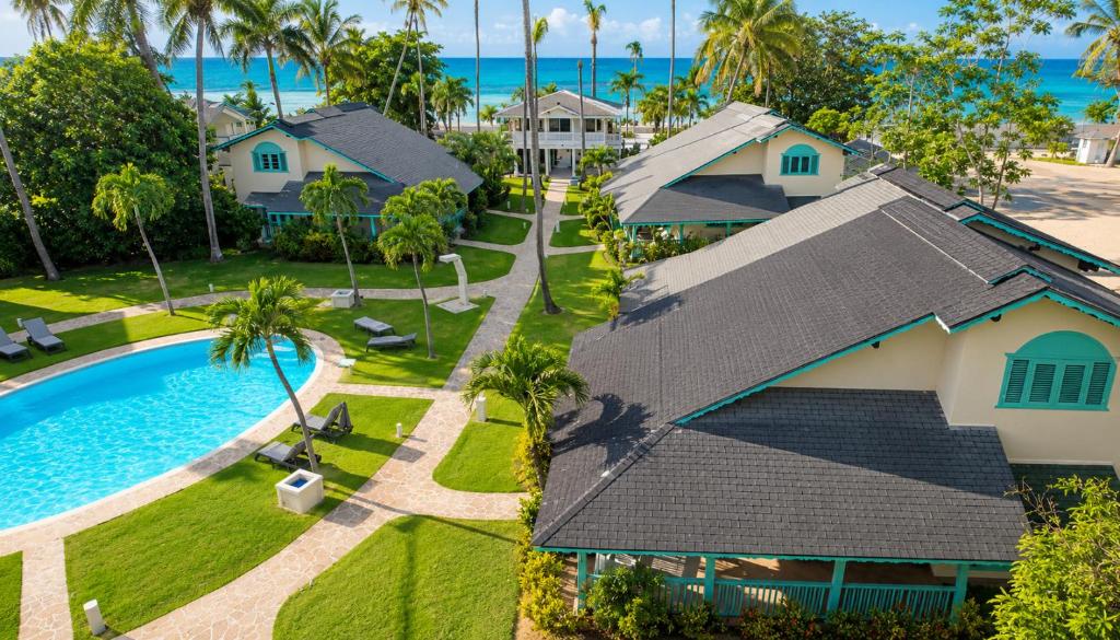 an aerial view of a house and a swimming pool at Villas Palmar Residence Beachfront Villas & Studios in Las Terrenas