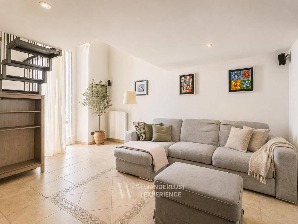 a living room with a couch and a table at Wanderlust Experience Fronte Porto in Bari