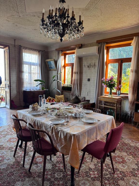 a dining room with a table with wine glasses on it at Kolagis Marani in Kolagi