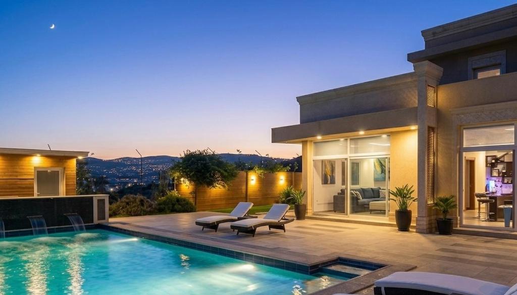 a house with a swimming pool in the backyard at Luxury Farm Villa with Private Pool in Jerash