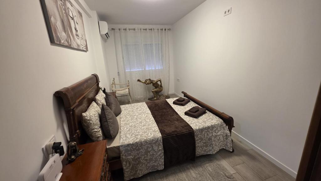 a bedroom with a bed and a chair in it at Lovely Holiday in Alicante