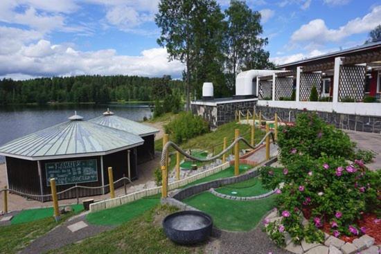 a playground in front of a building with a slide at Hotel Lahnajärvi in Lahnajärvenkylä