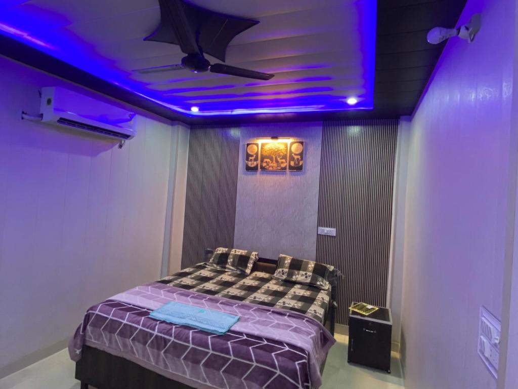 a room with a bed with a purple ceiling at Samrat Hotel in Sonīpat