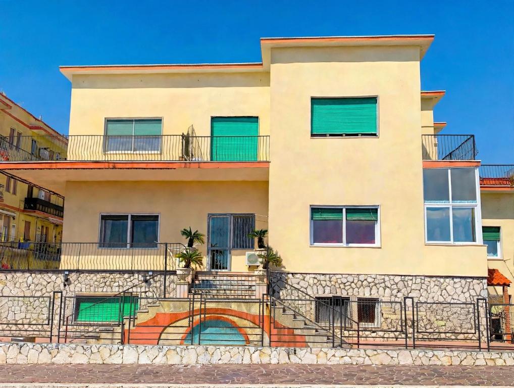 a building with green shutters on it at Casa Vacanze Formia in Formia