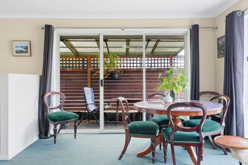 a dining room with a table and chairs at Kings Corner in Sandy Bay