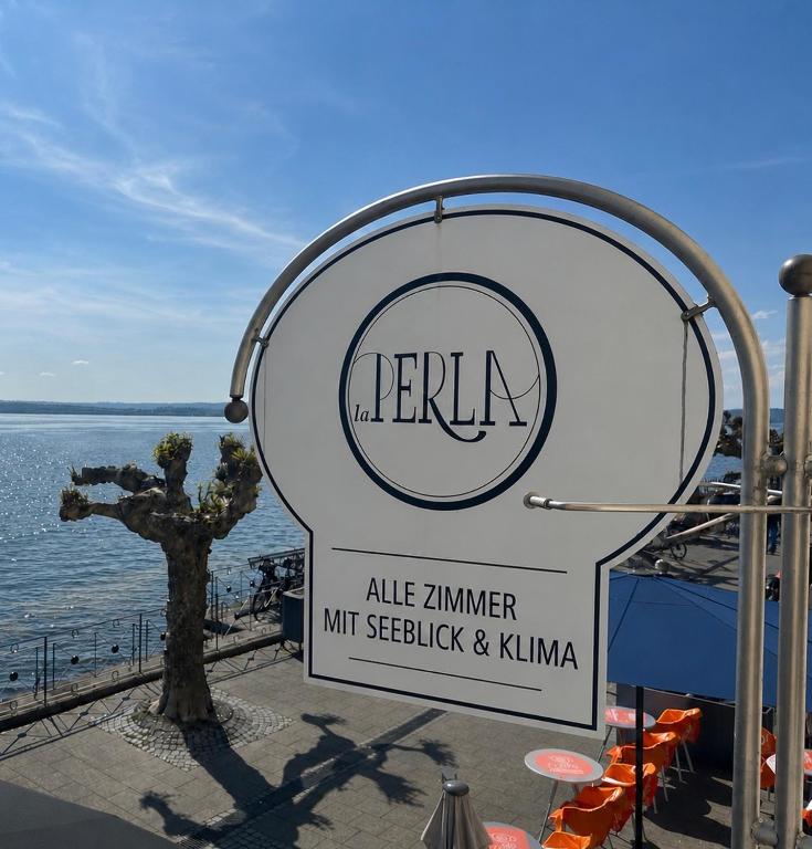 a sign for a marina with a lake interpretermtrocket and kima at Hotel la Perla in Meersburg