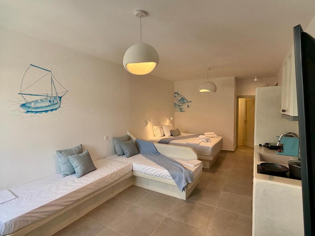 a living room with two beds and a couch at Apollonia Studios in Katapola