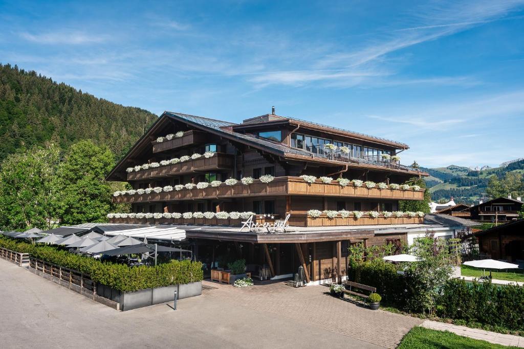 a large building with balconies on the side of it at Hotel Arc-en-ciel Gstaad in Gstaad