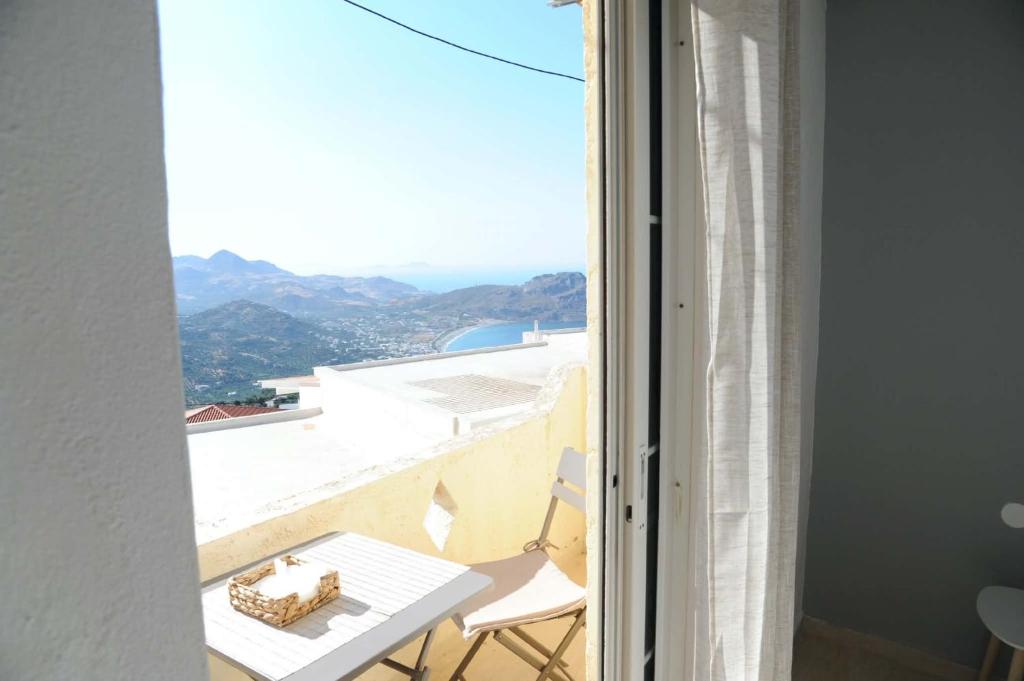 a room with a white table and a view from a window at MR RedNikos in Sellía