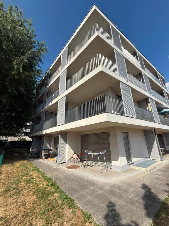 a large apartment building with a table in front of it at Apart Leman in Ecublens