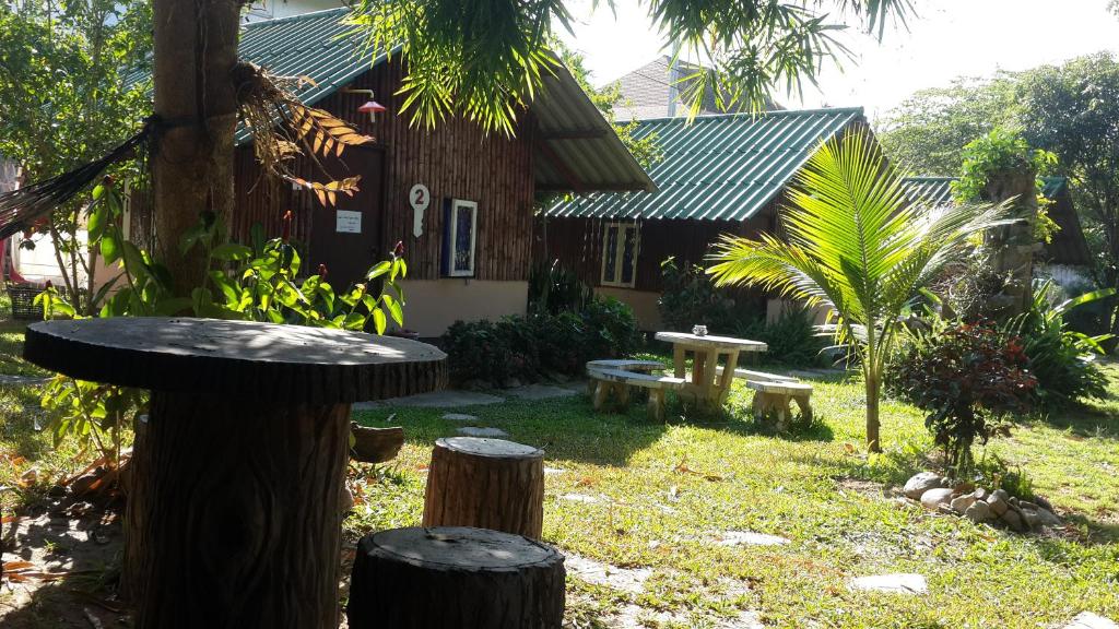 un jardín con una mesa y una casa en Rainbow House Pai, en Pai