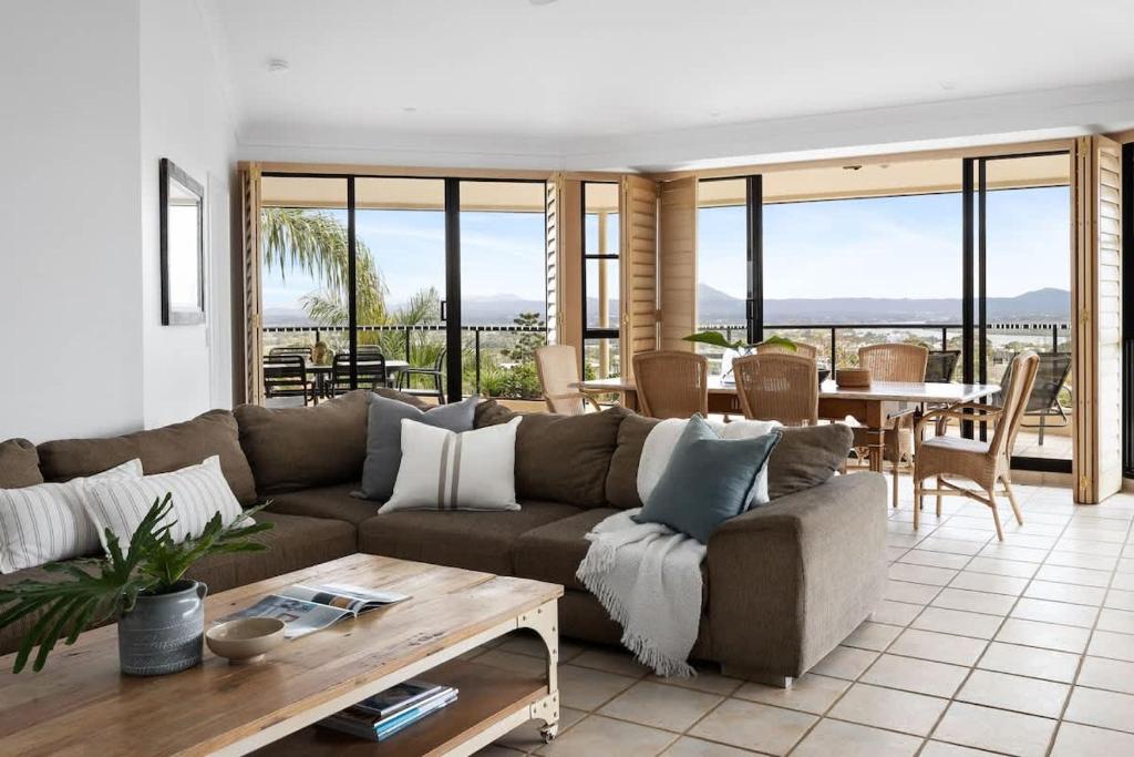 a living room with a couch and a table at Penthouse with Incredible Views & Pool in Noosa Heads