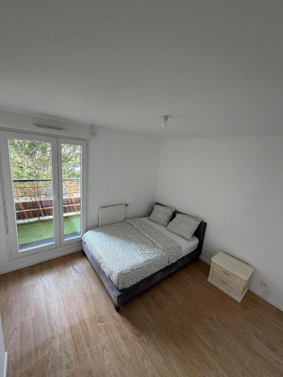 a bedroom with a bed and a large window at Modern 2BR Train, Versailles, Paris in Plaisir