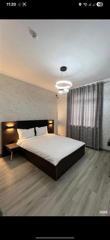 a bedroom with a large bed in a room at Van park hotel in Shymkent