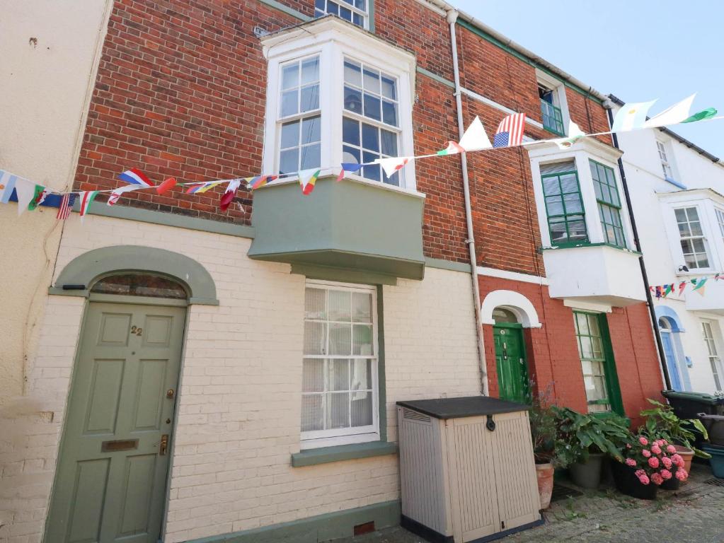 a house with flags on the side of it at The Watch House in Weymouth
