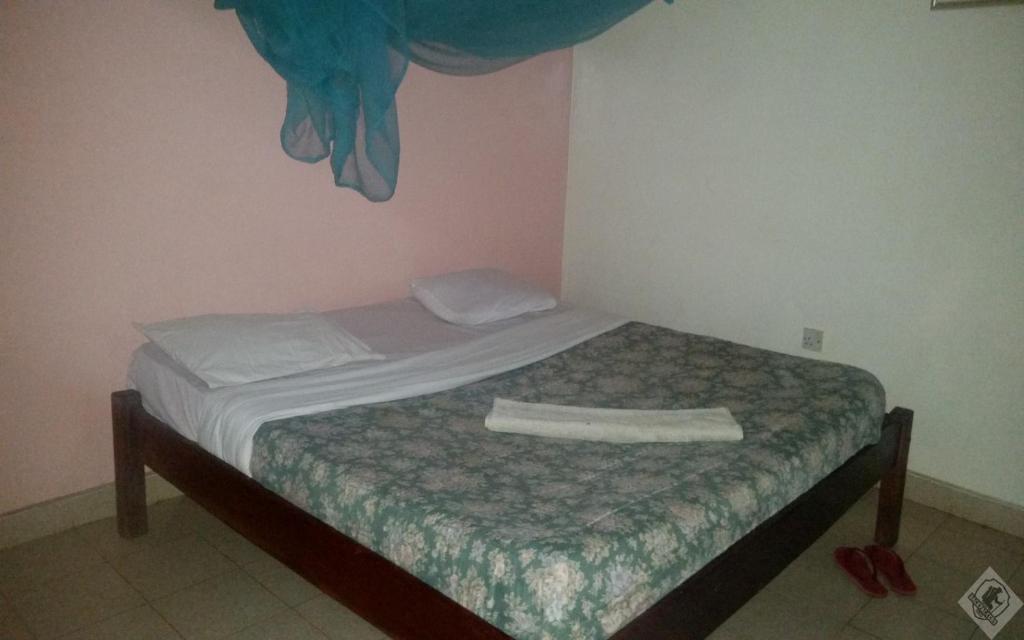 Postel nebo postele na pokoji v ubytování Mamba Village Kisumu