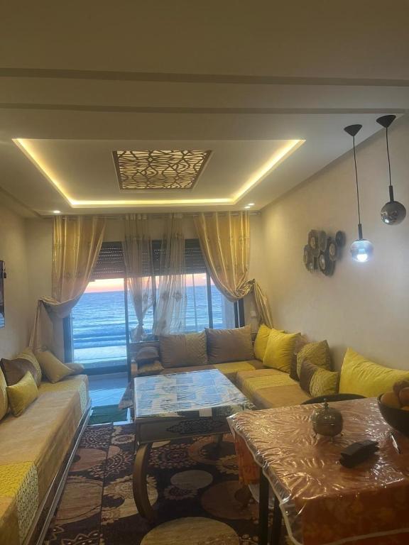 a living room with a couch and a table at Perle de LAtlantique in Kenitra