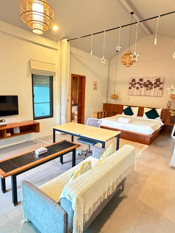 a living room with a couch and a table at Tropical Crystal Villa in Salad Beach