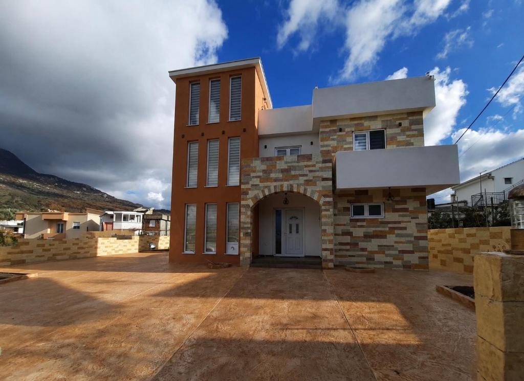 a large brick building with a white door at Vila Sami in Bar