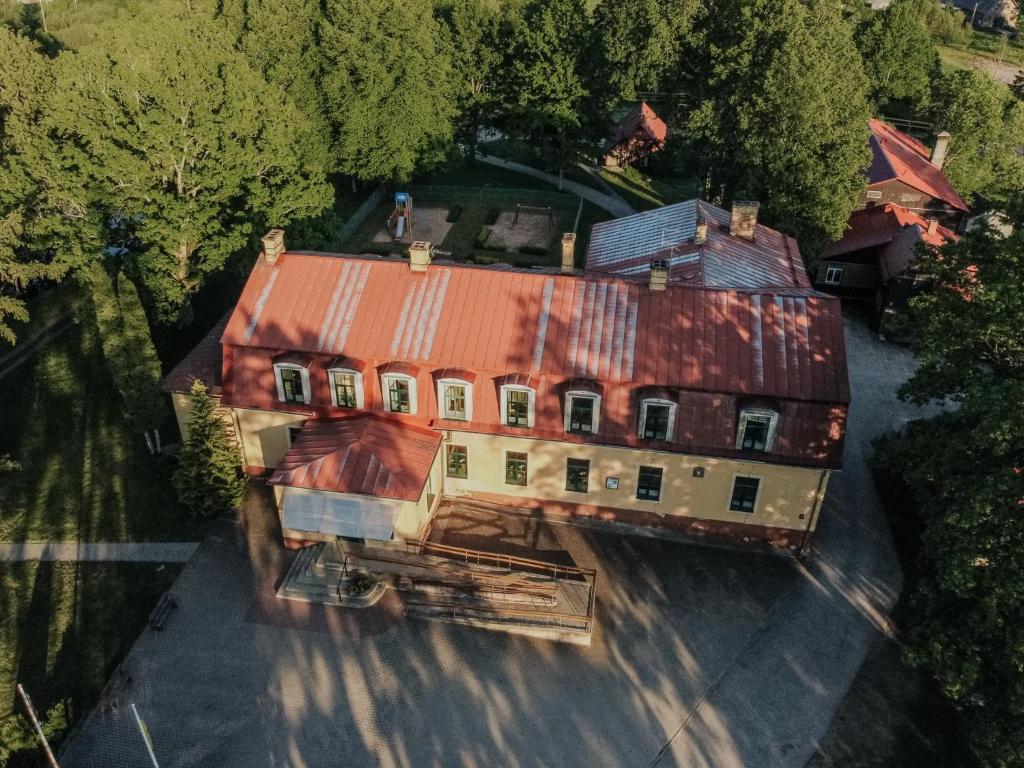 an overhead view of a house with a rusty roof at Spāres muiža in Spāres Muiža