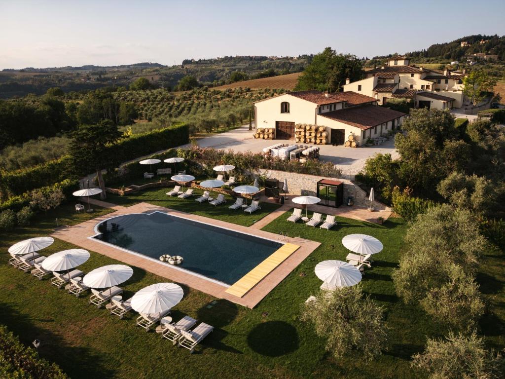 an aerial view of a villa with a swimming pool at The Podere Wine Resort Chianti in Barberino di Val dʼElsa