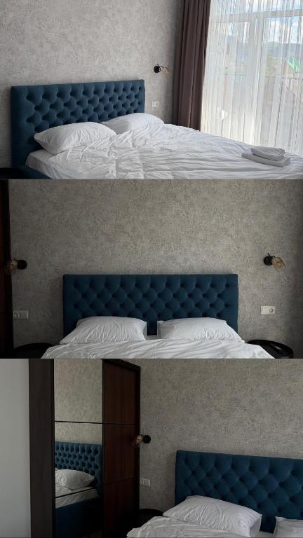 a bedroom with a blue bed and a mirror at Старий Дуб in Mizhhirya