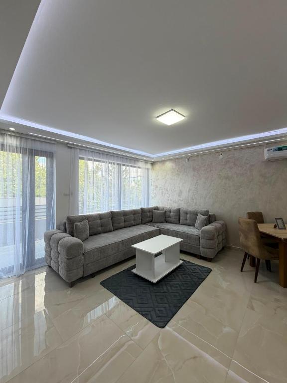 a living room with a couch and a table at melvina LUX in Pančevo