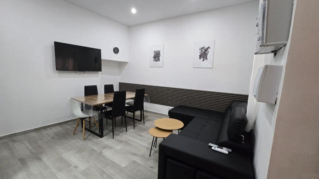 a living room with a couch and a table at Casa NOU in Cullera