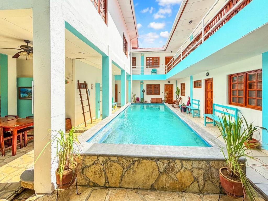 a swimming pool in the middle of a house at Hotel Gracia in San Juan del Sur