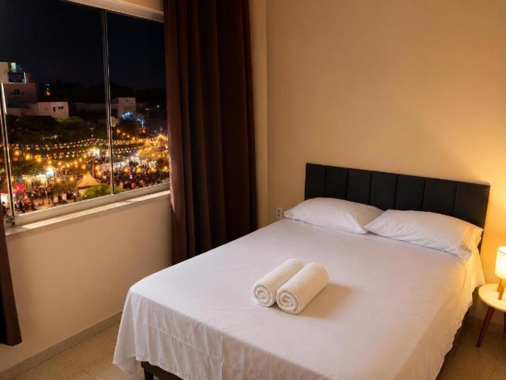 a bedroom with a bed with two towels on it at Confort Quixada in Quixadá