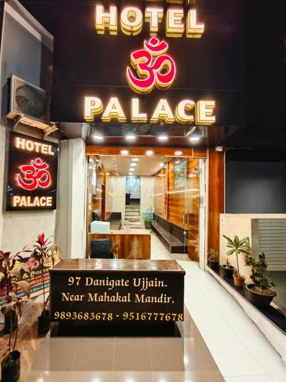 a hotel palace sign in front of a building at HOTEL OM PALACE NEAR MAHAKALESHWAR TEMPlE in Ujjain