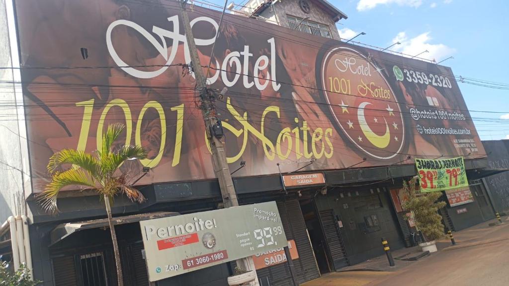 a building with a sign on the side of it at Hotel 1001 noites samambaia ADE in Brasília