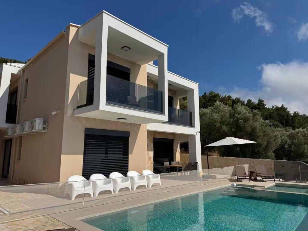 a house with a swimming pool next to a building at villa efraim read the details from the host for approval in Athens
