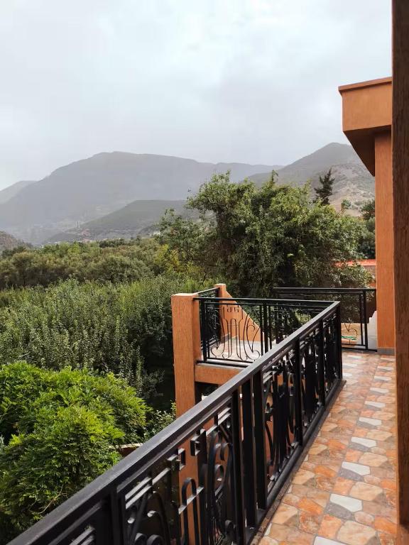 a bench on a balcony with mountains in the background at La Maison Nature , Mountains View Suite in Ourika