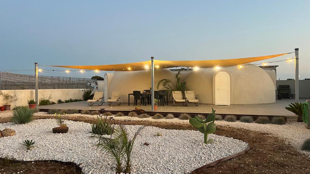 a house with a patio with a table and chairs at Nausicaa Guesthouse in Marsala