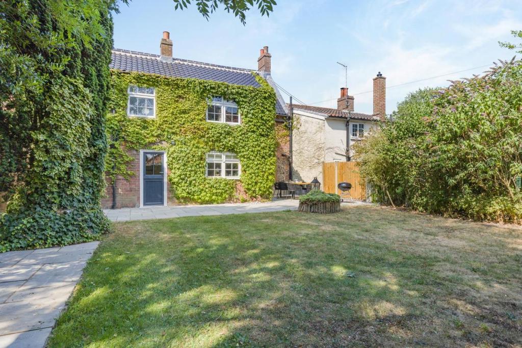 an ivy covered house with a yard at 4 Bed in East Rudham oc-t28312 in East Rudham