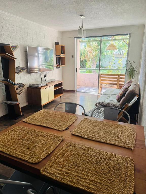 a room with a table with chairs and a desk at Refugio las pircas in Vicuña