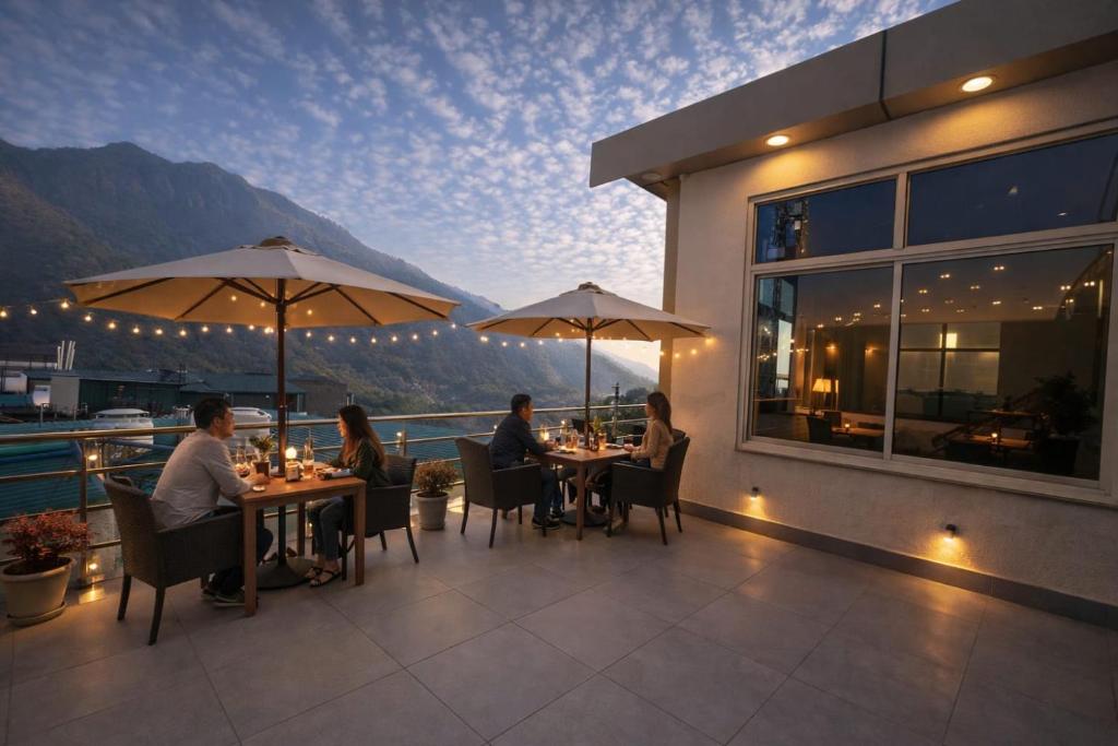 a group of people sitting at tables on a patio at Sitara Premium Dhakad Gold, Near Lakshman Jhula, Tapovan in Rishīkesh