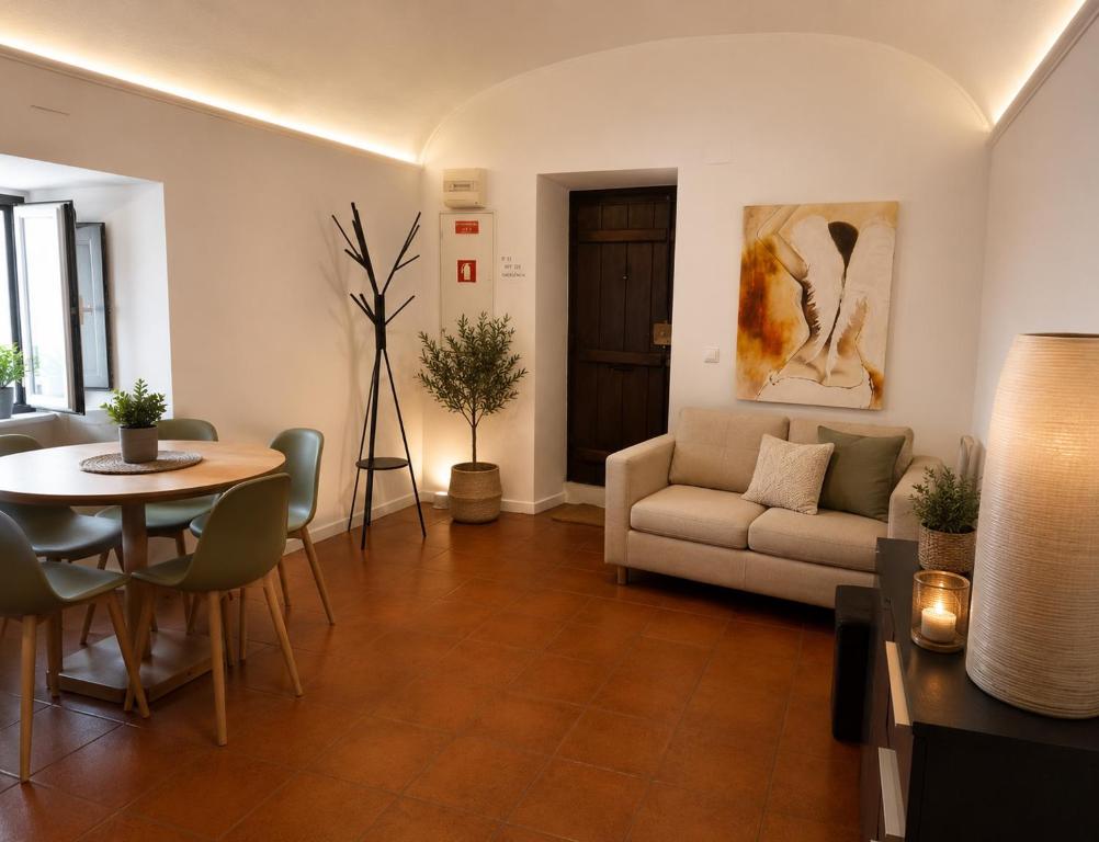 a living room with a couch and a table at Casa do Arco II in Évora