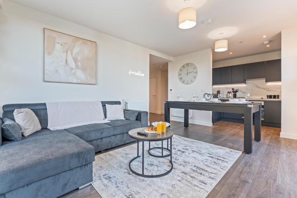 a living room with a couch and a table at 2 Bed Flat, Pool Table, Terrace 4 stops to Wembley in Hatch End