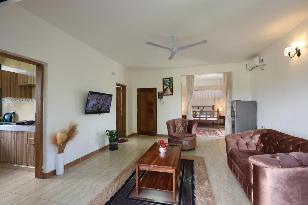 a living room with a couch and a table at Diani Luxe Villa 1bdr A, 600m from the beach in Galu