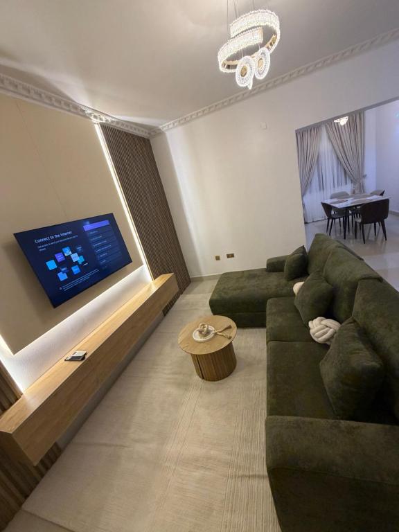 a living room with a couch and a flat screen tv at Was Homes in Abuja