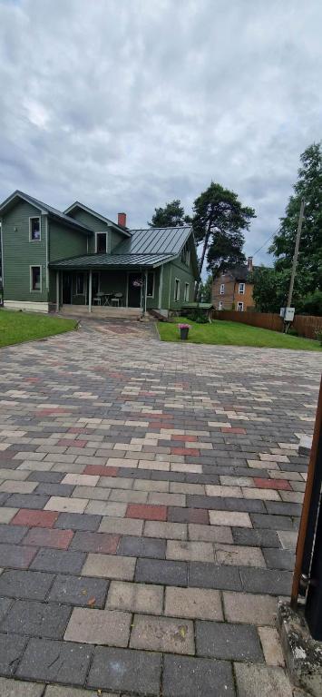 a house with a brick driveway in front of a house at Elva südalinna kodumajutus in Elva