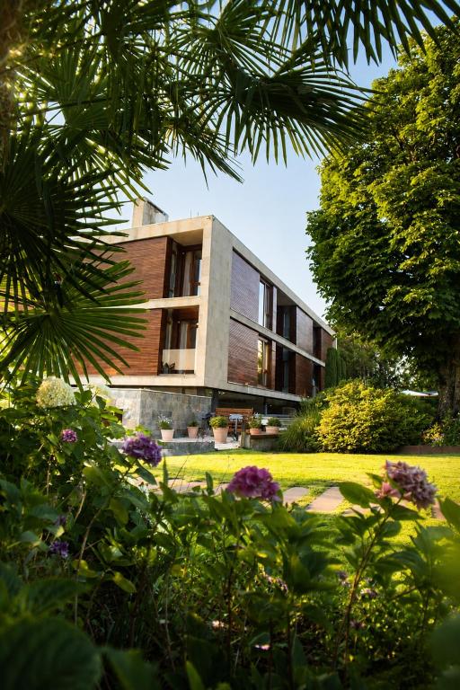 a house in the middle of a garden with flowers at Hotel Jaizkibel in Hondarribia