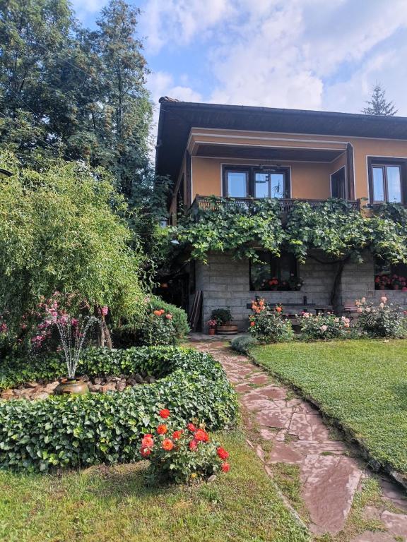 a house with ivy growing on the side of it at Dona Guest House - Horse Riding in Koprivshtitsa