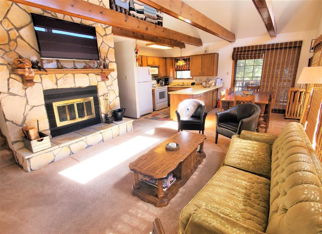 a living room with a couch and a fireplace at A Frame of Mind in Red River