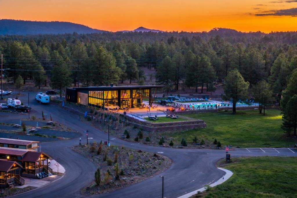 an aerial view of a building with a sunset in the background at Village Camp Flagstaff in Bellemont