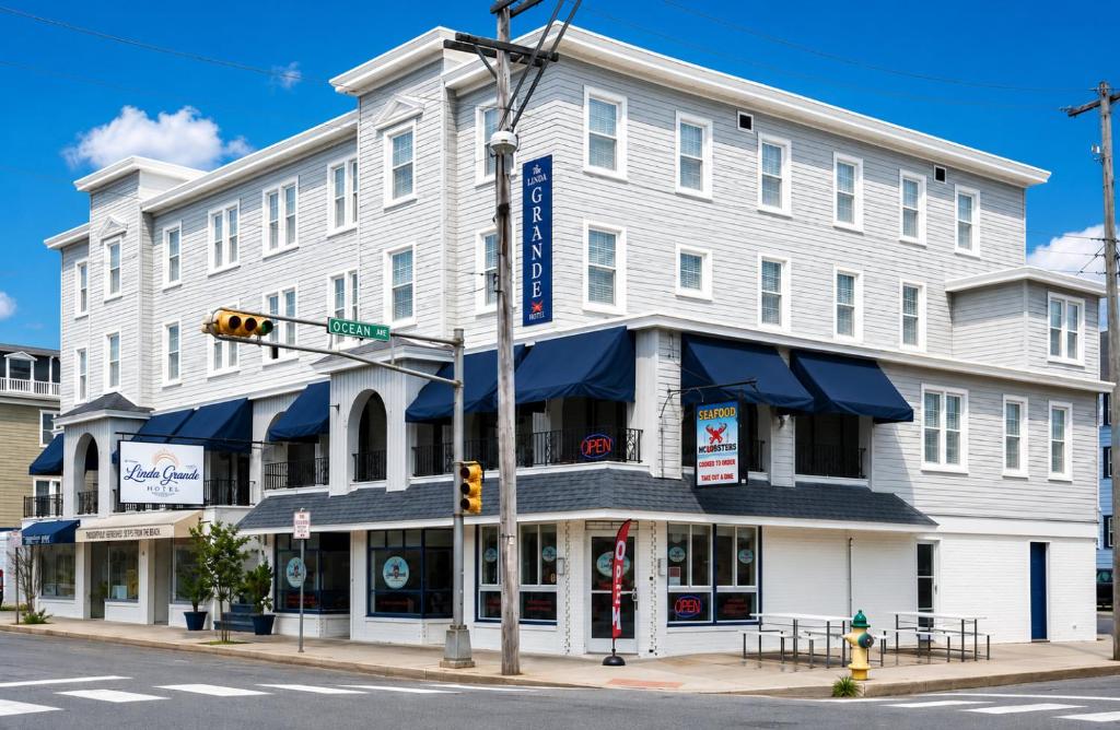 a white building on a street corner with a traffic light at The Linda Grande Hotel in Ocean City